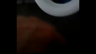 Peeing into a porcelain urinal